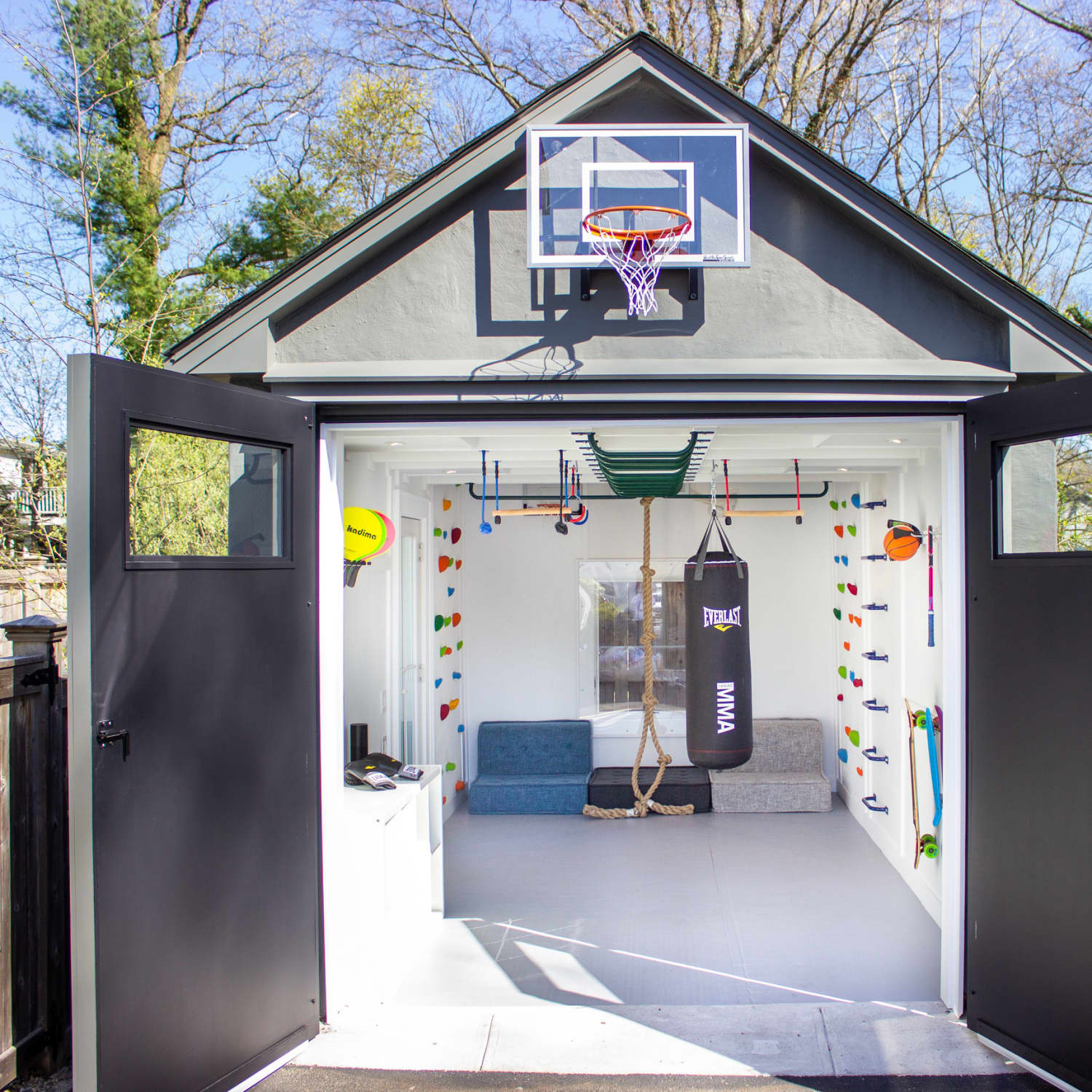 Home garage converted into a gym with basketball hoop.