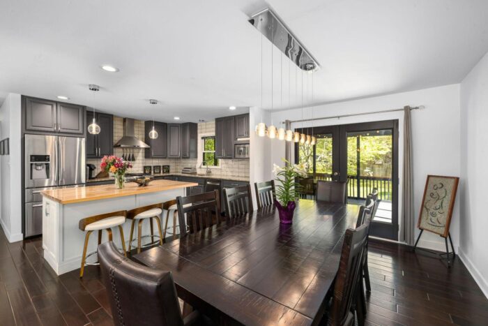 Modern kitchen and dining area with dark wood table