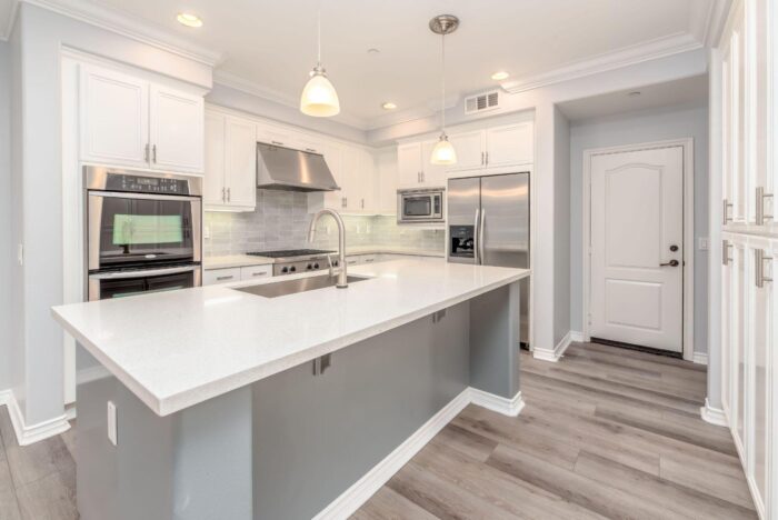 Modern white kitchen with island and stainless appliances