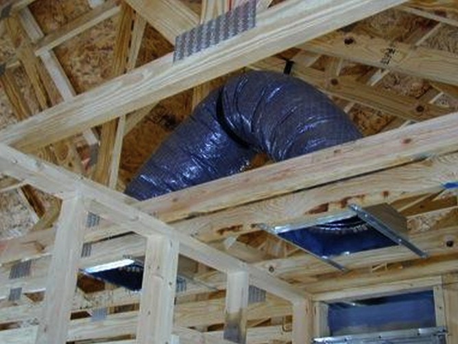 Flexible HVAC ductwork installed between unfinished ceiling joists